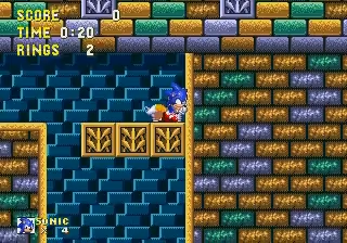 First frame of an embedded video clip: Sonic the Hedgehog inside a wall of blue and gold blocks, the SCORE / TIME / RINGS heads-up display in the top corner.