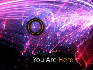 Map of North America overlaid with a dense pink and purple glowing network, captioned “You Are Here” with one node circled in yellow